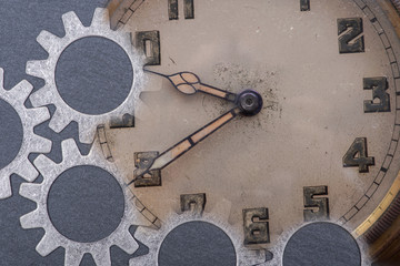 Panta rhei concept: antique, old, vintage pocket watch and hour metal gears on natural stone background