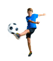 A full-length shot of Boy playing soccer kicking the ball on isolated white background