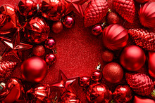 Red Christmas Frame. Christmas Balls, Stars, Cones And Hearts On Red Sparkles Background. Flat Lay. Top View. Copy Space