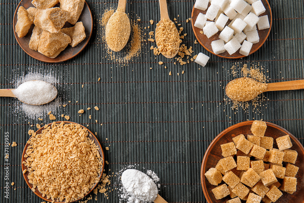 Different kinds of sugar on dark table