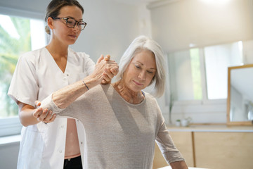 Wall Mural - Senior woman with her physiotherapist