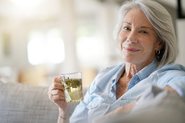 Wall Mural -  Modern senior woman at home with tea