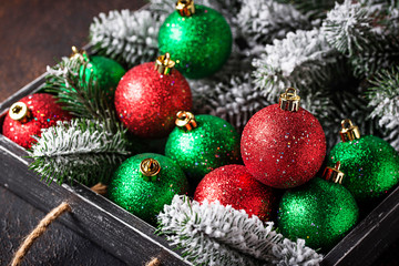 Red and green Christmas tree balls in wooden box