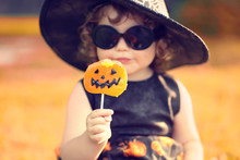 Little Girl Witch In Black Pointed Hat And Sunglasses