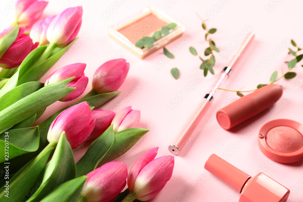 Beautiful tulips with cosmetics on color background