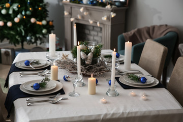 Beautiful table setting with Christmas decorations in living room