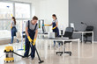 © Pixel-Shot - Team of janitors cleaning office