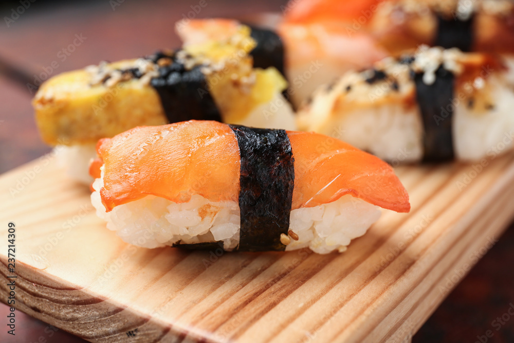 Tasty sushi on wooden stand, closeup