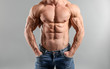 © Pixel-Shot - Muscular bodybuilder on grey background