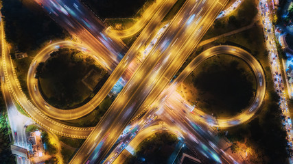 Wall Mural - Aerial top view highway road intersection roundabout or circle at night for transportation, distribution or traffic background.