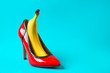 © Pixel-Shot - High heel shoe and banana on color background. Erotic concept