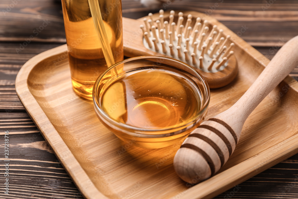 Wooden plate with natural cosmetics for hair on table
