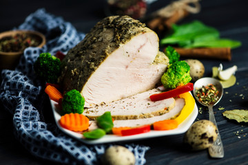 homemade baked turkey meat with spices on a wooden board