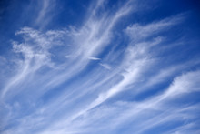 Long White Feathery Clouds On A Blue Sky
