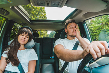 couple in car. tired driver. road trip