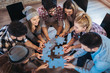 © Mediteraneo - Businesspeople joining puzzle pieces in office