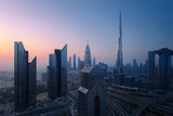 Fototapeta Na sufit - Dubai skyline in the morning, aerial top view to downtown city center landmarks at sunrise. Famous viewpoint, United Arab Emirates