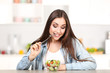 © 5second - Beautiful woman eating fresh salad in the kitchen