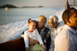 © Erickson Stock - Mature adult couple sitting with their young granddaughter while on a boat.