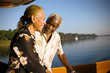 © Erickson Stock - Mature adult couple standing on a boat at sunset.