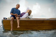© Erickson Stock - Happy mid-adult couple on a boat together on the ocean.