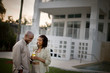 © Erickson Stock - Smiling husband and wife standing together in the back yard.