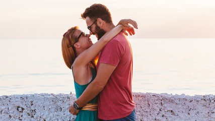 Wall Mural - Young couple in love enjoying their honeymoon at the seaside