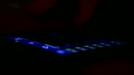 Man uses a smartphone in the dark close up