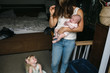 © Rob and Julia Campbell/Stocksy - Toddler crying to stressed out young mom