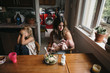 © Rob and Julia Campbell/Stocksy - Real family dinner with stressed out mom, busy kids and all the chaos