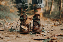 Woman Wearing Leather Boots Full Of Leaves