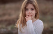 Cute little child with finger on lips making a silent gesture. Shh concept, be quiet