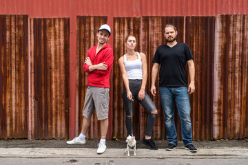 happy group of friends smiling and standing while posing against