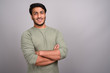 © Ranta Images - Portrait of young handsome Indian man against gray background