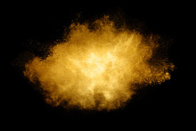 Golden Color Explosion. Glitter Dust Particles Isolated On Black Background