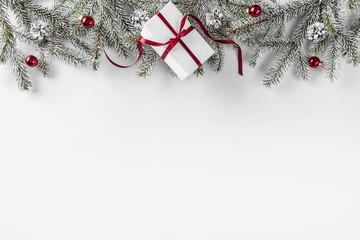 Wall Mural - Christmas gift boxes on white background with Fir branches, pine cones, red ribbon. Xmas and Happy New Year theme. Flat lay, top view