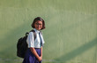 © Dream Lover/Stocksy - teenage girl with school dress laughing and looking at camera