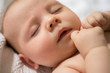 © jamie grill atlas/Stocksy - Closeup of sleeping baby