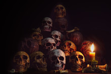 Pile Of Skulls And Bones Lighting By Candlelight / Still Life Image And Dim Light And Adjustment Color For Background