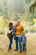 © Leah Flores/Stocksy - Cute Family Posing for Fall Portrait