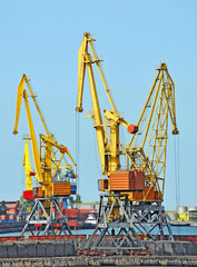 Port cargo crane over blue sky background