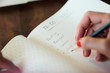 © Guille Faingold/Stocksy - Hand writing plan in notepad