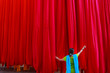 © Dream Lover/Stocksy - A woman holding the hanging colorful red clothes for drying purpose in a textile industry