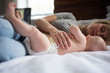 © jamie grill atlas/Stocksy - Mother nursing baby on bed