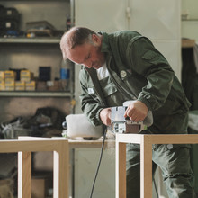 Man In The Uniform Working At The Furniture Factory