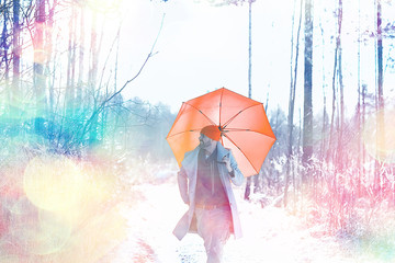 Wall Mural - winter walk with an umbrella / man in a coat with an umbrella, walk against the backdrop of the winter landscape, winter view