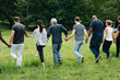 © Rawpixel.com - Diverse people holding hands and running in the park