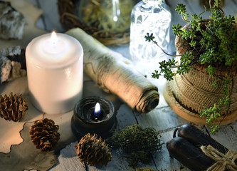 Black and white candles, cones, succulent and parchment on planks. Magic gothic ritual. Wicca, esoteric and occult background 