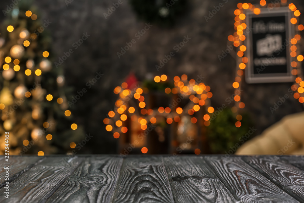 Closeup view of wooden table against blurred Christmas interior