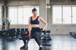 © Nawarit - Beautiful girl caucasian is exercising with lifting dumbbell in the gym. Female athletes play a healthy training session.
